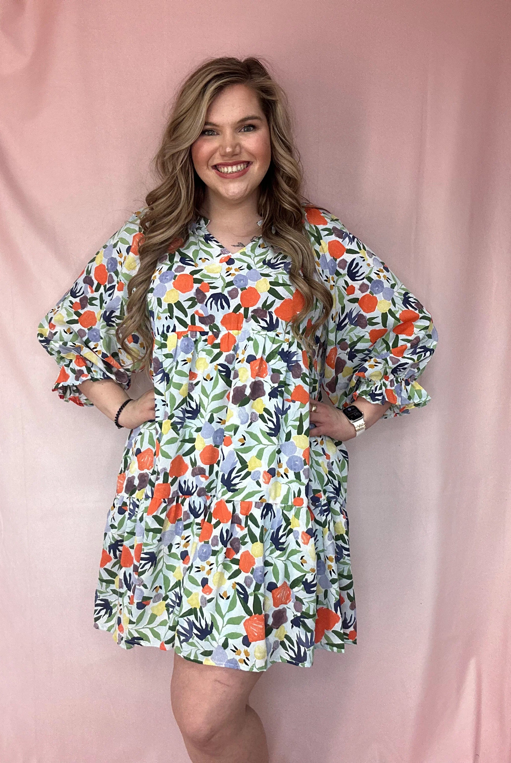 Girl Wearing A Long Puff Sleeve Orange, Blue, and Sage Floral Print Dress | Podos Boutique