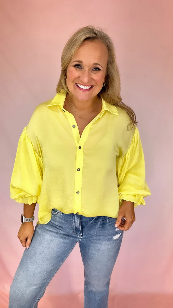 Girl Wearing A Long Puff Sleeve Yellow Button Up Top | Podos Boutique