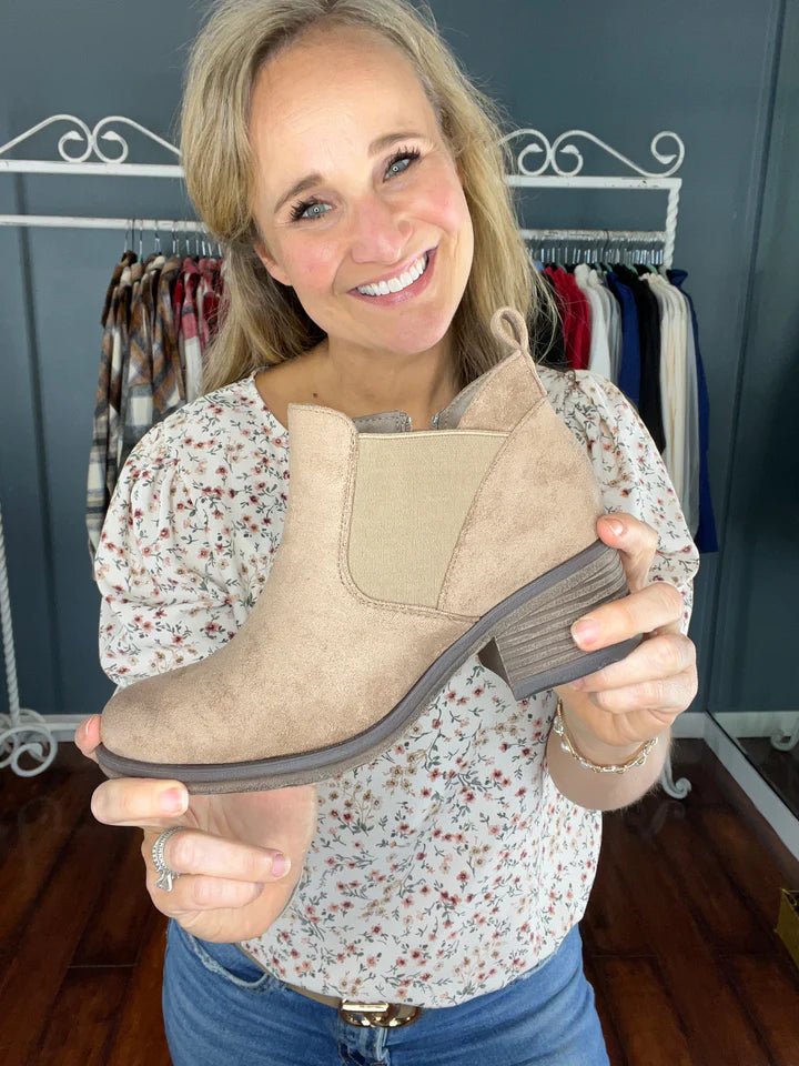 Girl Holding A Tan Ankle Bootie | Podos Boutique